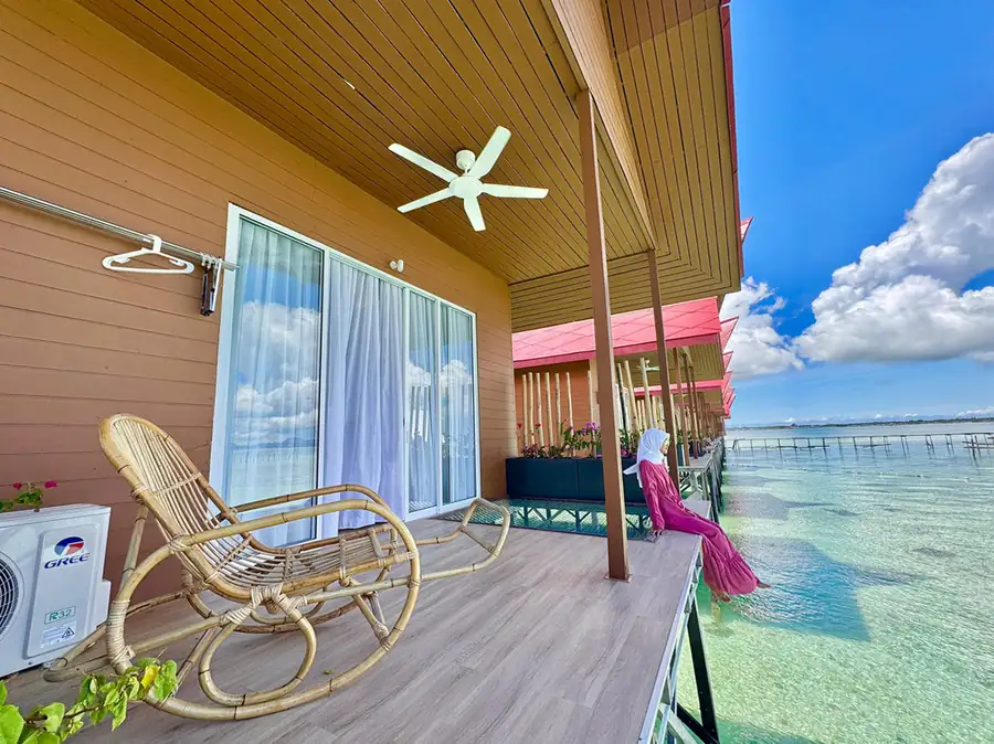 Guest on a private ocean-facing sun balcony with glass floor section at Sand Bay Resort