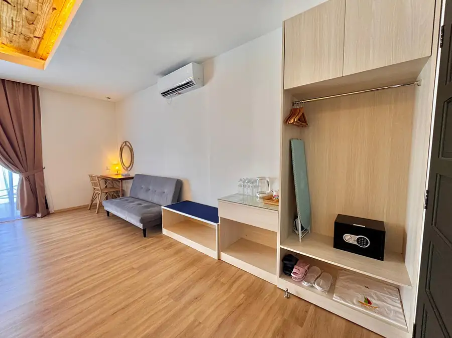 Family room with grey sofa and wooden desk with glass-panel doors at Sand Bay Resort