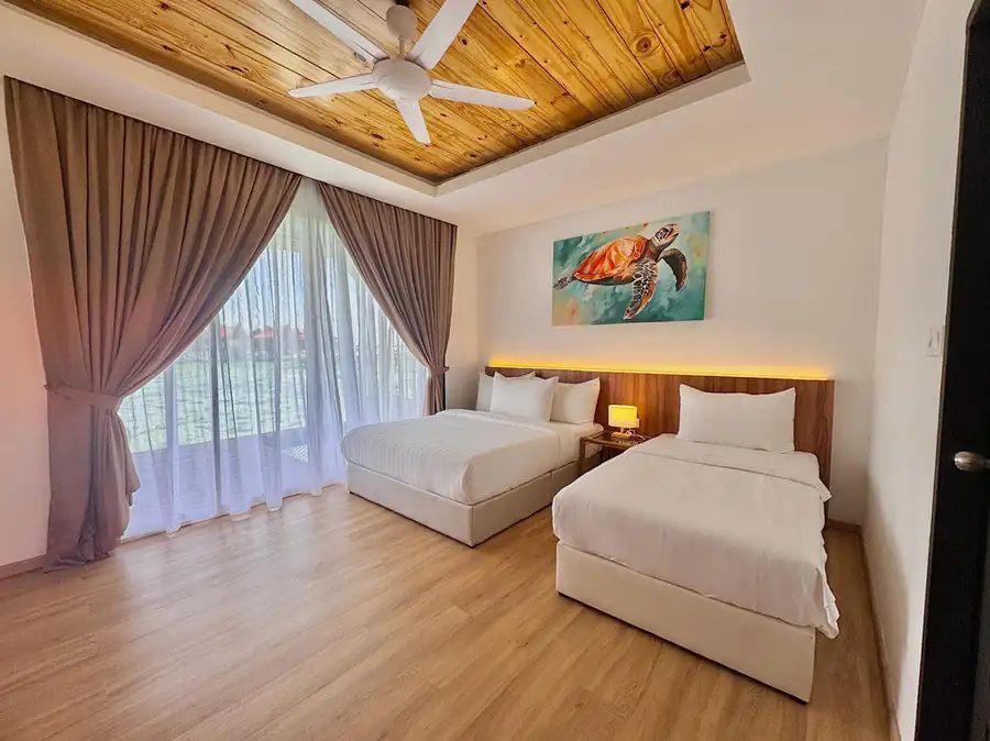 Bedroom with one large bed and one single bed by glass-panel doors at Sand Bay Resort