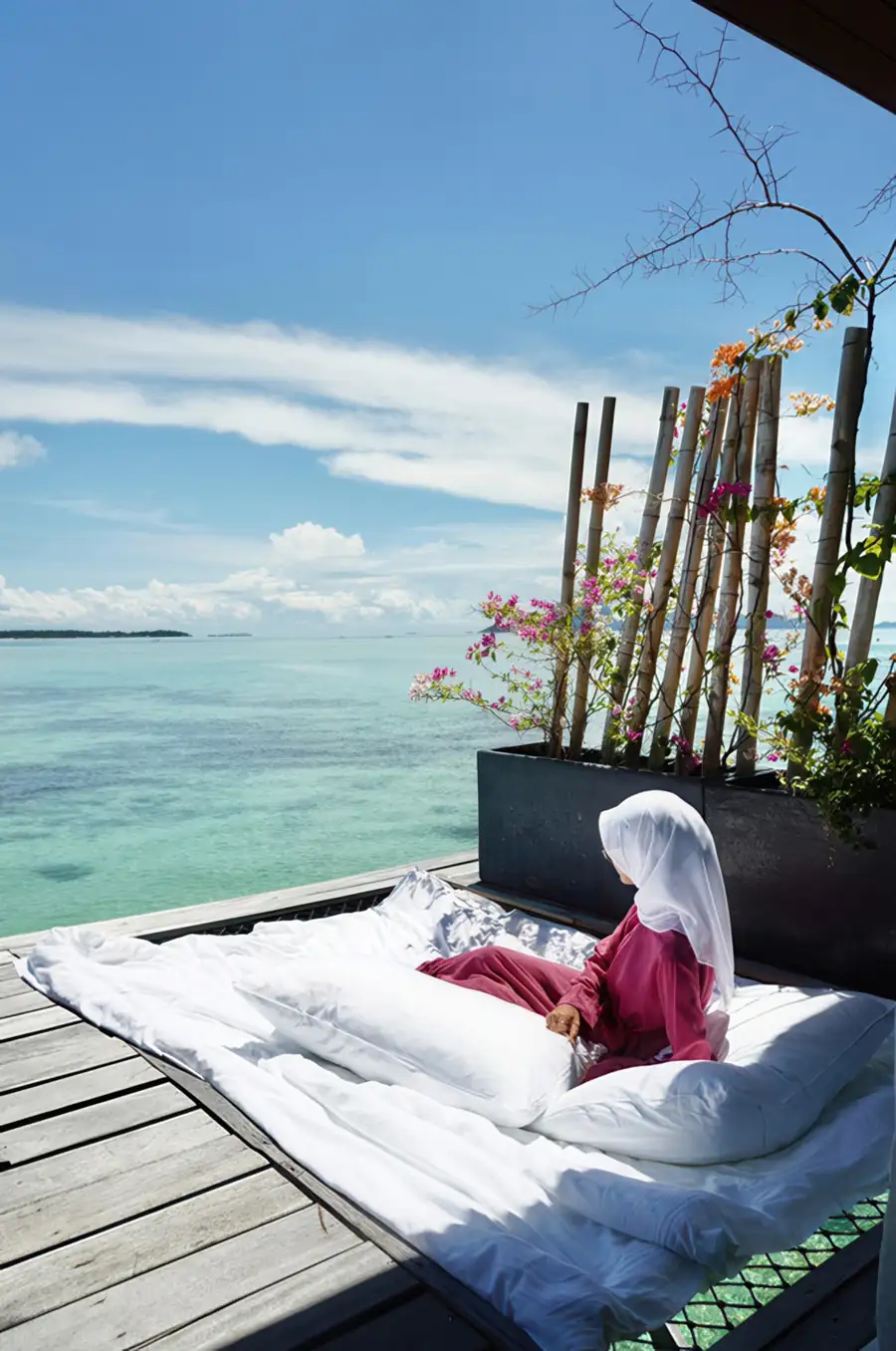 Private balcony with hanging swing chair and overwater hammock net at Sand Bay Resort